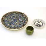 Three assorted ceramic items to include a charger with hand painted arabesque floral decoration,