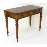 A late 19thC mahogany side table with two short drawers having turned wooden handles and standing