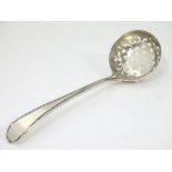 A silver sifter spoon.