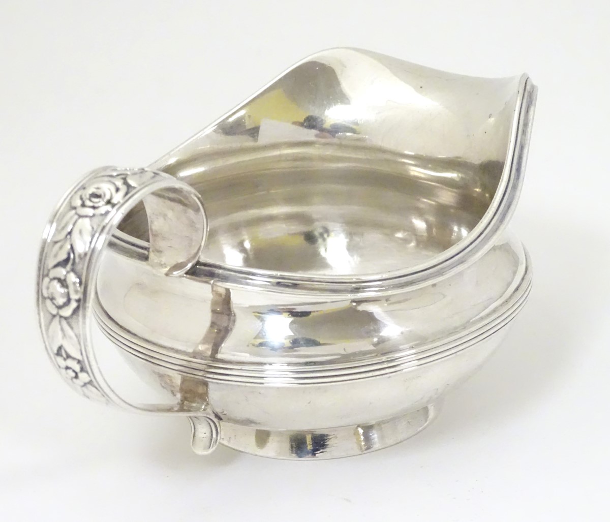 A silver jug / sauce boat with floral decoration to handle hallmarked London 1826 maker William - Image 4 of 8