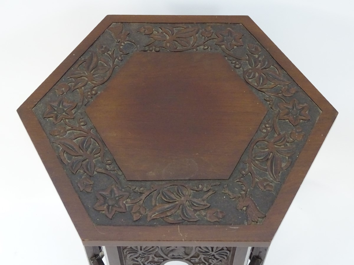 A walnut Liberty style table with a hexagonal carved top above six matching carved facades with - Image 5 of 13