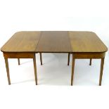 A 19thC mahogany D-ended dining table raised on tapering squared legs and having an additional leaf.