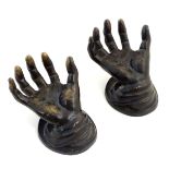 Two cast bronze sculptures modelled as hands with palms up on a round base. Approx. 4 1/2" high.