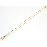 A 9ct gold necklace with wishbone formed pendant set with diamond.