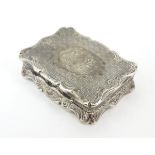A Victorian silver vinaigrette with engraved and decoration and gilded interior.