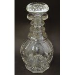 A 19thC cut glass three ring decanter and stopper. Approx. 8 1/2" high.
