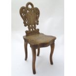 A mid 20thC music box in the form of a chair,