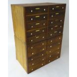 A pair of mahogany banks of drawers each containing 10 short drawers with small porcelain knob