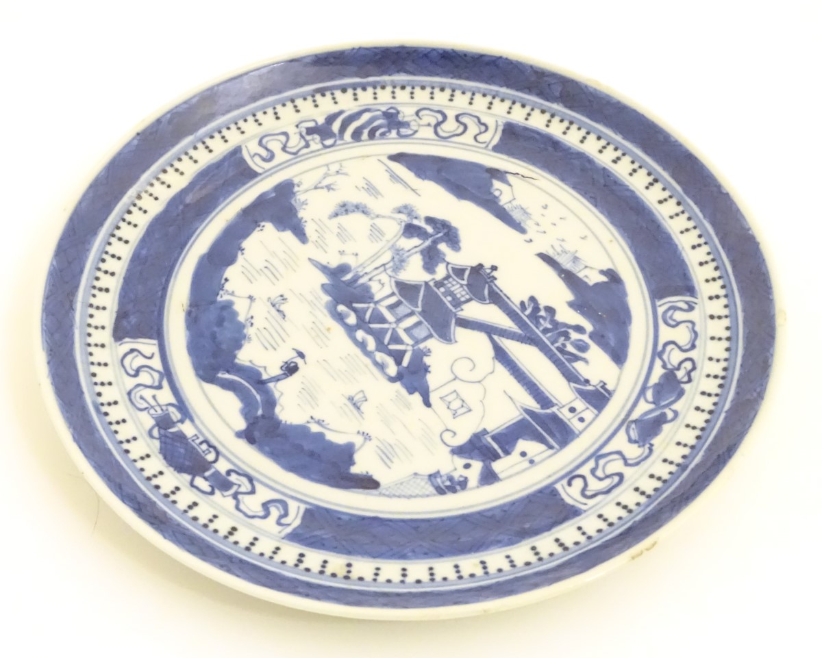 A Chinese blue and white plate with hand painted decoration depicting a pagoda on an island, - Image 4 of 6