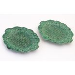 A pair of Wedgwood majolica oval plates with a green lustre glaze,