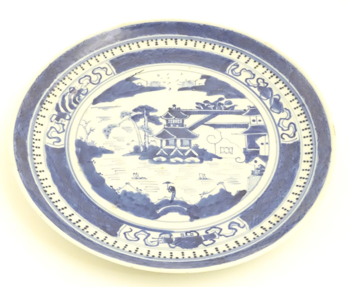 A Chinese blue and white plate with hand painted decoration depicting a pagoda on an island, - Image 3 of 6