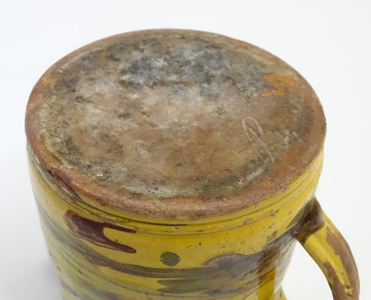 A 19thC studio pottery slipware jug with a yellow ground. Indistinct incised mark under. Approx. - Image 7 of 7