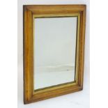 An early / mid 20thC birdseye maple mirror with a gilt painted surround.