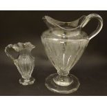 An Irish glass water jug c.1800, together with a 19thC cut glass cream jug. Tallest approx. 9" high.