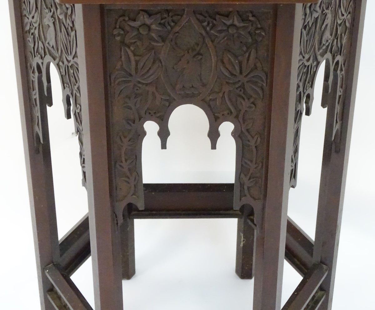 A walnut Liberty style table with a hexagonal carved top above six matching carved facades with - Image 9 of 13