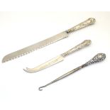 A silver handled bread knife together with a cheese knife and a button hook (3)