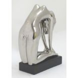 A 21stC sculpture of a nude woman with a chromed style finish,