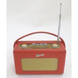 A late 20thC Roberts R250 portable radio, with red vinyl covering,