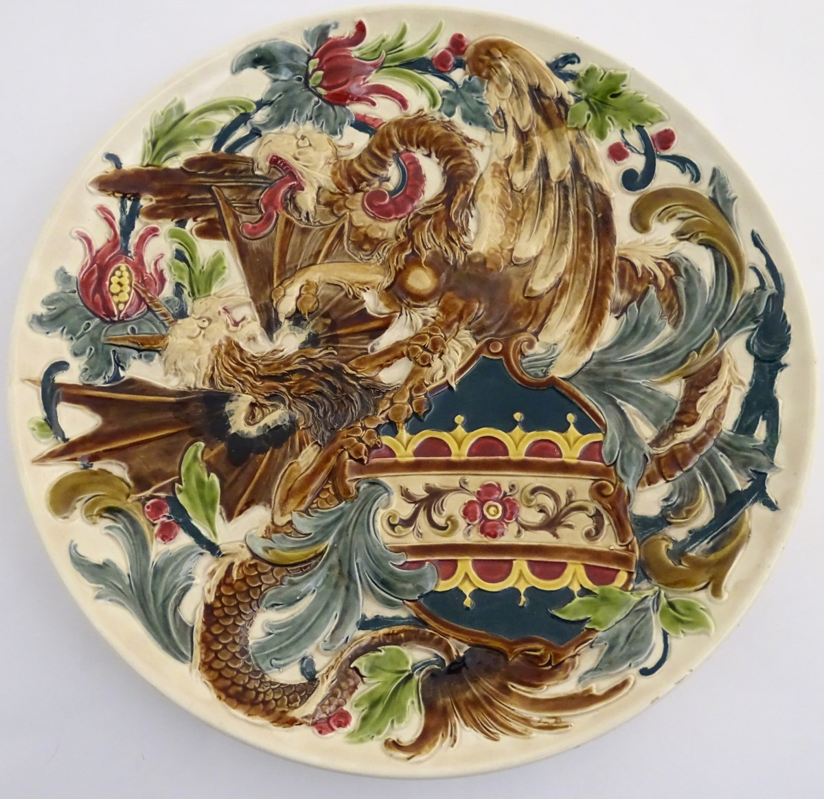 A large 19thC Austrian charger decorated in relief with two fighting griffins / dragons with a - Image 3 of 8