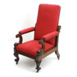 A Victorian mahogany reclining open armchair with carved arms,