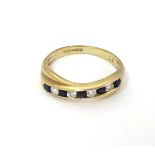 A 9ct gold ring set with white and black stones CONDITION: Please Note - we do