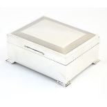 A silver Art Deco style table top cigarette box with engine turned decoration hallmarked Birmingham
