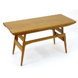 A vintage retro metamorphic low/dining table, of teak construction,