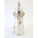 A 21stC novelty cocktail shaker formed as a lighthouse. Impressed mark under. Approx. 14" high.