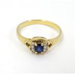 An 18ct gold ring set with sapphire flanked by diamonds CONDITION: Please Note -