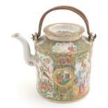 A Cantonese famille verte teapot with panelled decoration depicting flowers, butterflies and birds,