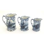 Three Victorian blue and white graduated jugs with transfer decoration depicting landscapes with