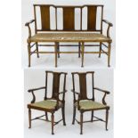 A Richard Norman Shaw Tabard suite comprising two open armchairs and a settee,