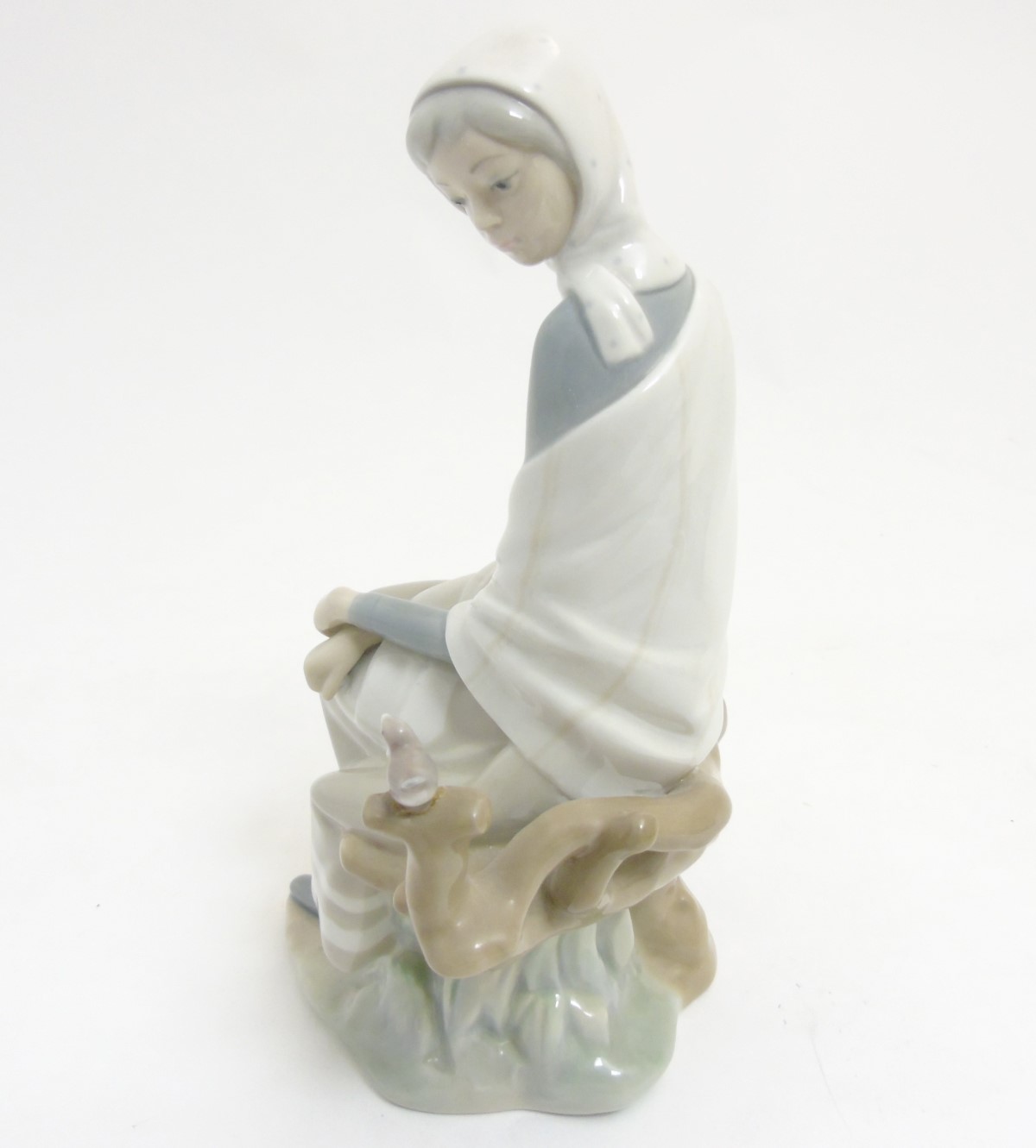 A Lladro 'New Shepherdess' figurine of a girl sat watching a bird, makers mark to base, - Image 7 of 8