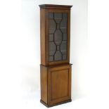 A late 19thC / early 20thC mahogany cabinet with a moulded cornice above an astragal glazed door