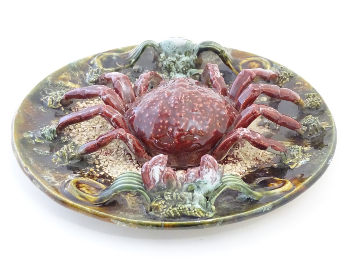 A 20th Portuguese Palissy style majolica dish / plate with an applied model of a crab on a bed of