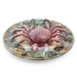 A 20th Portuguese Palissy style majolica dish / plate with an applied model of a crab on a bed of