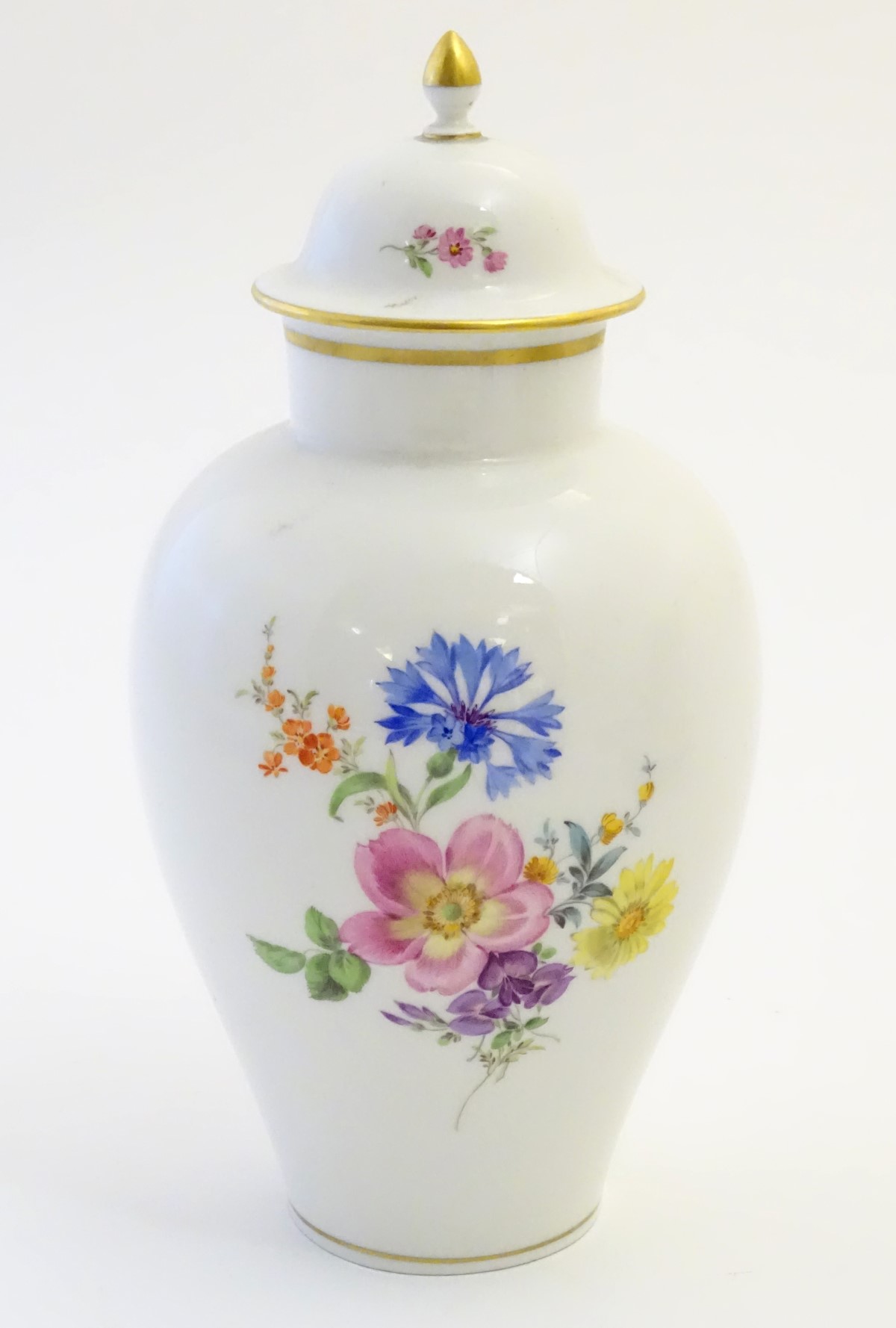 A Continental lidded vase with hand painted floral decoration. Meissen style marks under. Approx.