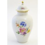A Continental lidded vase with hand painted floral decoration. Meissen style marks under. Approx.
