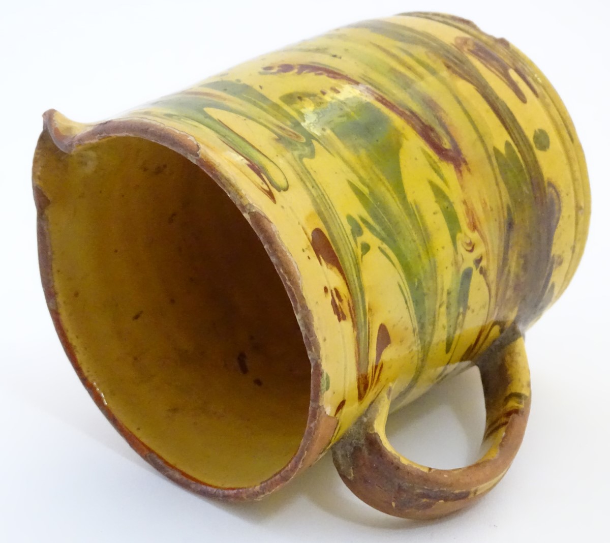 A 19thC studio pottery slipware jug with a yellow ground. Indistinct incised mark under. Approx. - Image 6 of 7