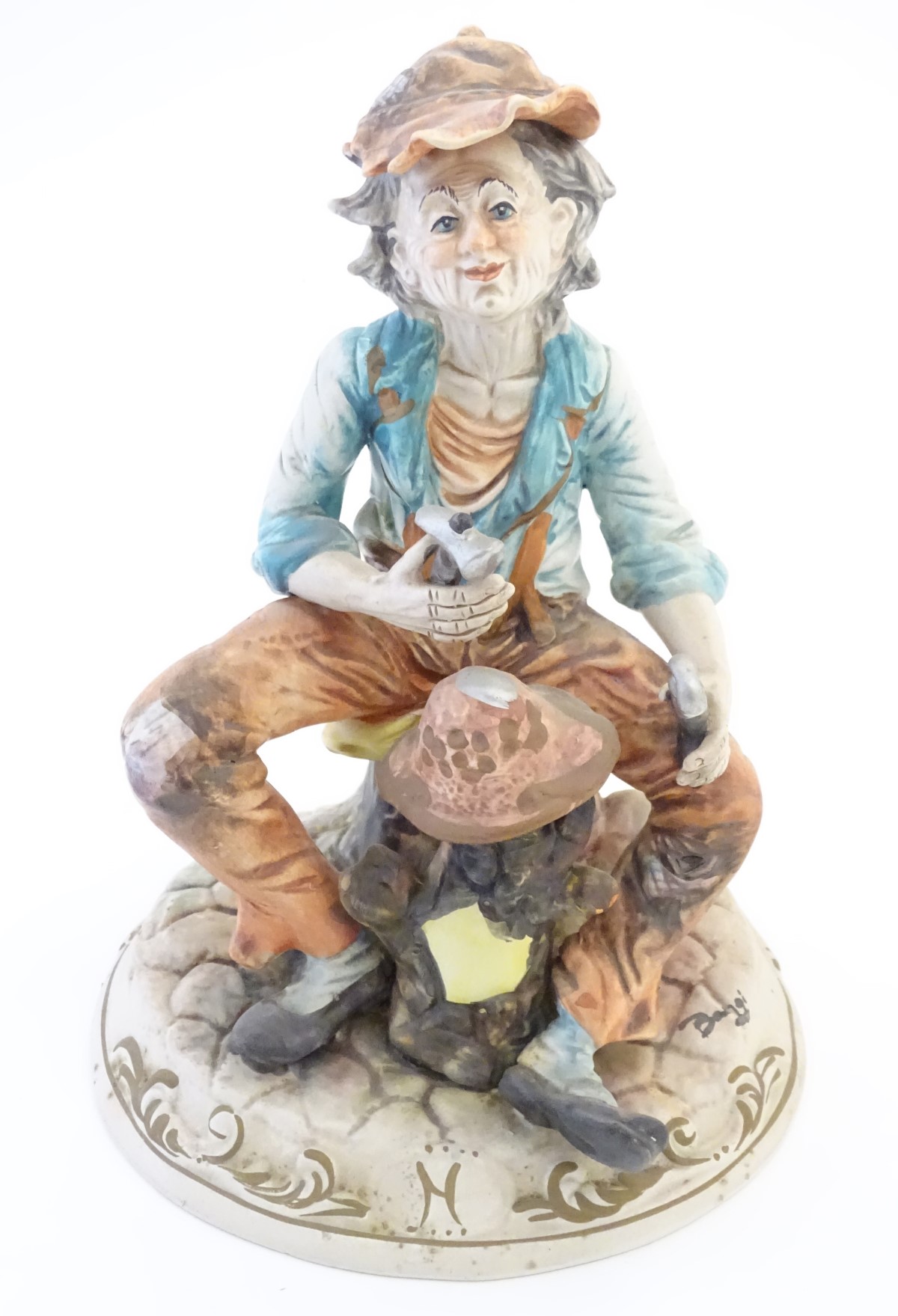 A Capodimonte figure of an elderly man with tools, possibly an armourer.