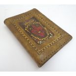 An Italian embossed and tooled leather book cover,