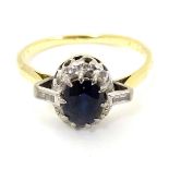 An 18ct gold ring set with central sapphire bordered by diamonds CONDITION: Please