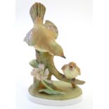 A Crown Staffordshire model of a flycatcher bird and its young, model no. 75. Marked under. Approx.