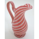 A 19thC water jug with pink and white banded candy stripe decoration. Approx. 7 3/4" high.