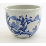 A Chinese blue and white jardiniere decorated with a mountainous landscape scene with figures,