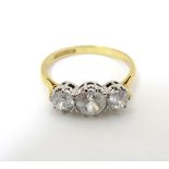 A ring set with three graduated white stones and marked ' 18ct gold' CONDITION:
