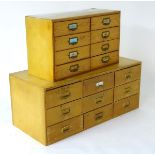 Two pine banks of drawers, one containing six drawers and the other containing nine short drawers.