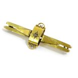 A gold bar brooch set with central diamond 2" wide