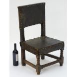 A 17thC childs chair with leather upholstery and brass stud detailing with block and bobbin turned