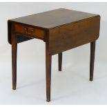An 18thC mahogany pembroke table with drop leaves to each side,